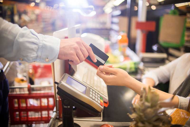 Hand passing credit card to merchant