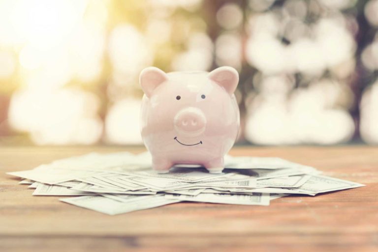 Piggy bank in front of a sunset